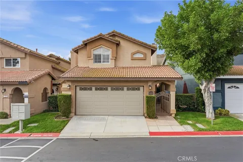 a front view of a house with a yard and a garage