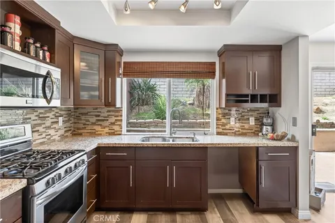 a kitchen with stainless steel appliances a sink stove and cabinets
