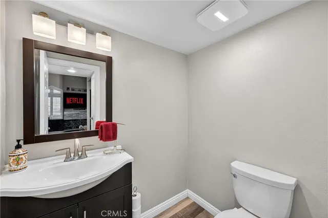 a bathroom with a sink a toilet and mirror