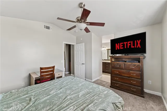 a bedroom with a bed and a television