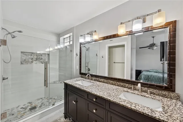 a bathroom with a granite countertop sink mirror and double