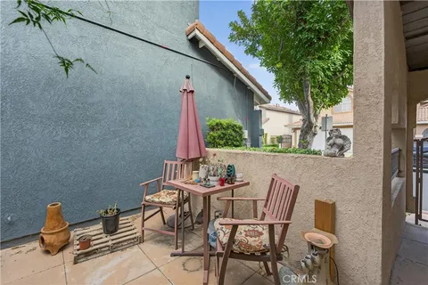 a patio with table and chairs