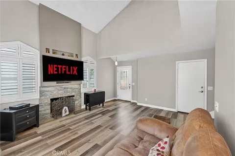 a living room with furniture flat screen tv and a fireplace