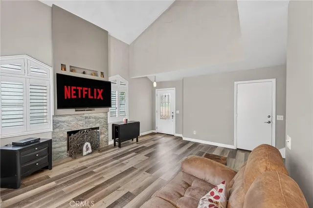 a living room with furniture flat screen tv and a fireplace