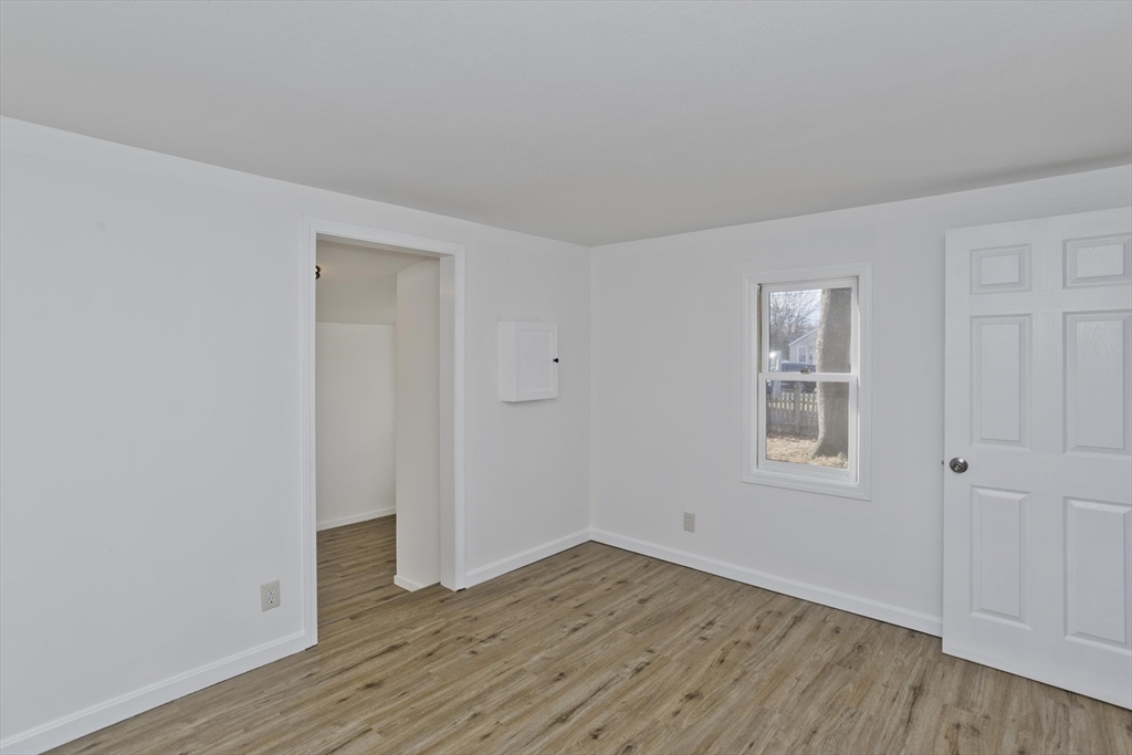 53 Champlain Street Springfield, MA 01151 - Photo 11 of 30 an empty room with wooden floor and windows