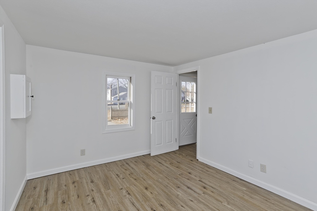 53 Champlain Street Springfield, MA 01151 - Photo 12 of 30 a view of an empty room with wooden floor and a window