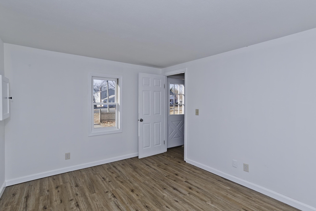 53 Champlain Street Springfield, MA 01151 - Photo 13 of 30 an empty room with wooden floor and windows