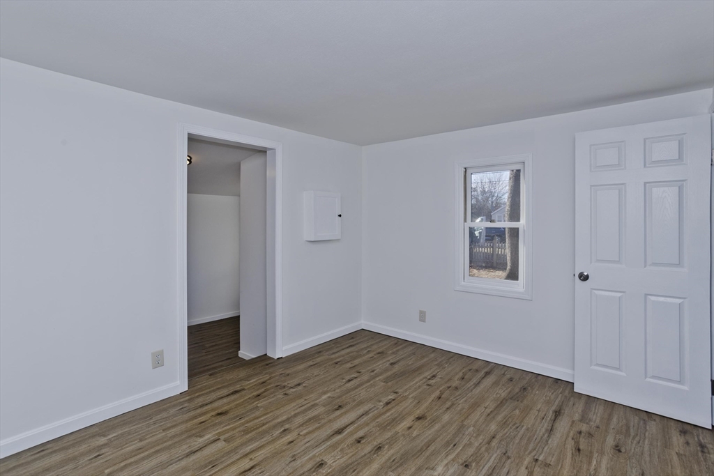 53 Champlain Street Springfield, MA 01151 - Photo 14 of 30 an empty room with wooden floor and windows