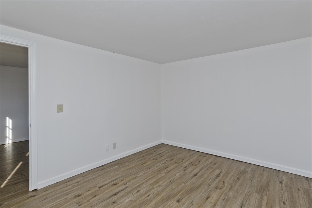53 Champlain Street Springfield, MA 01151 - Photo 15 of 30 a view of an empty room with wooden floor