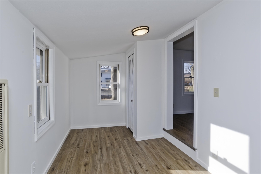 53 Champlain Street Springfield, MA 01151 - Photo 17 of 30 a view of a hallway with wooden floor and a bathroom