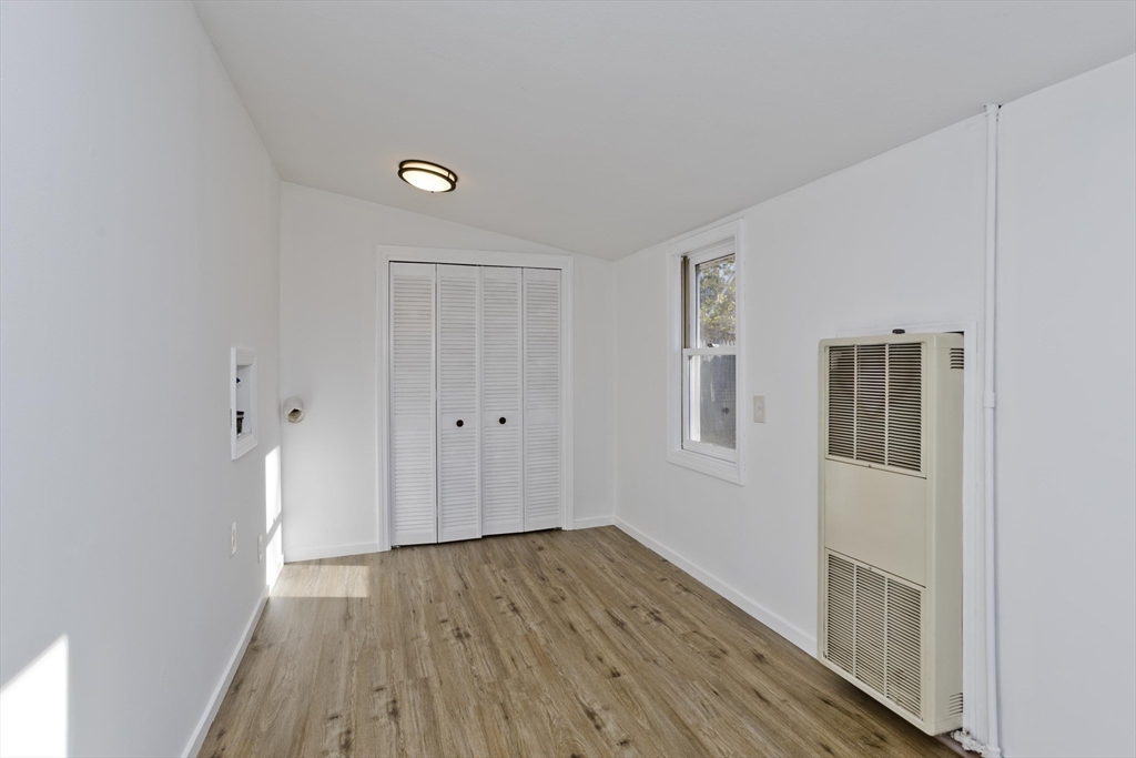 53 Champlain Street Springfield, MA 01151 - Photo 19 of 30 a view of an empty room with wooden floor