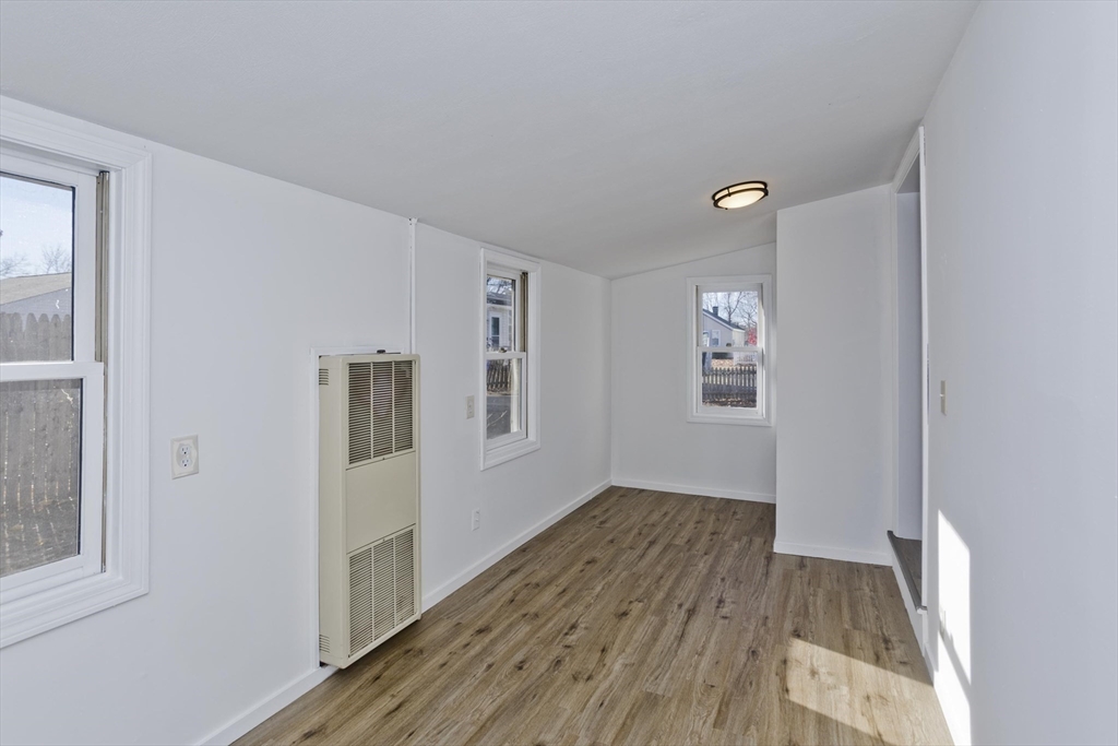 53 Champlain Street Springfield, MA 01151 - Photo 20 of 30 a view of an empty room with wooden floor and a window