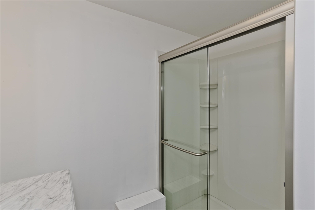 53 Champlain Street Springfield, MA 01151 - Photo 23 of 30 a bathroom with a glass shower door
