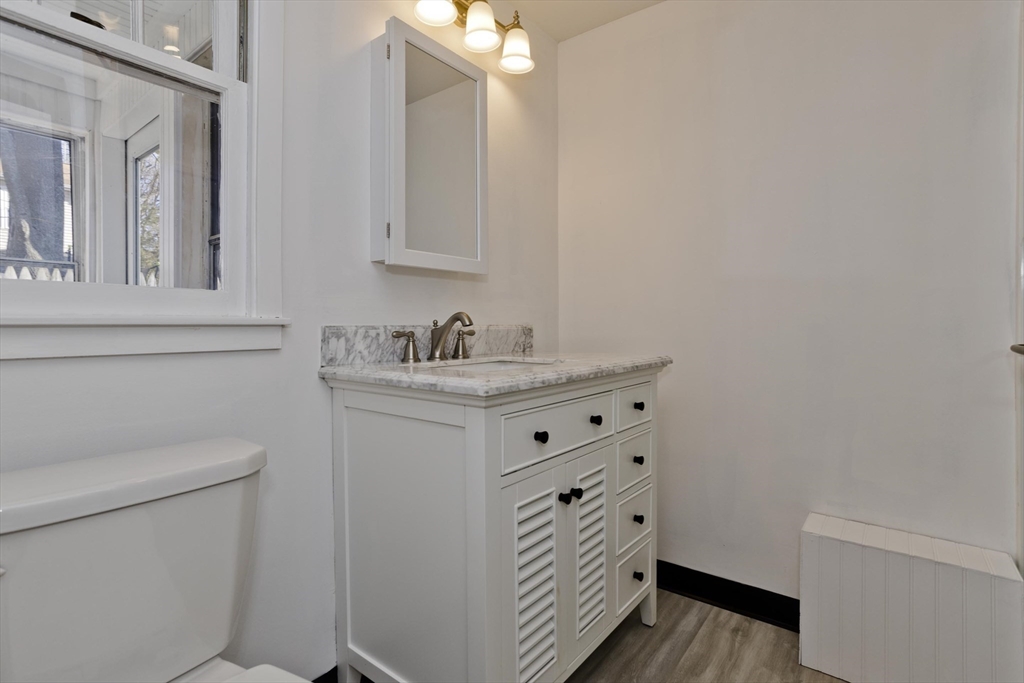 53 Champlain Street Springfield, MA 01151 - Photo 25 of 30 a bathroom with a sink a toilet and a mirror