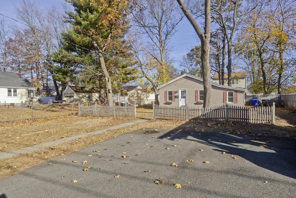 53 Champlain Street Springfield, MA 01151 - Photo 30 of 30 a view of a white house with a yard covered in snow