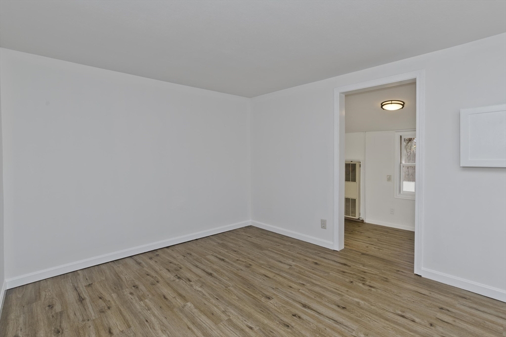 53 Champlain Street Springfield, MA 01151 - Photo 10 of 30 a view of an empty room with wooden floor and closet