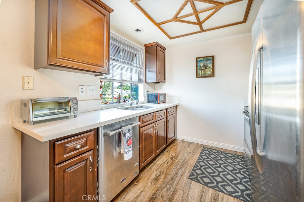 a kitchen with stainless steel appliances granite countertop a sink and a refrigerator