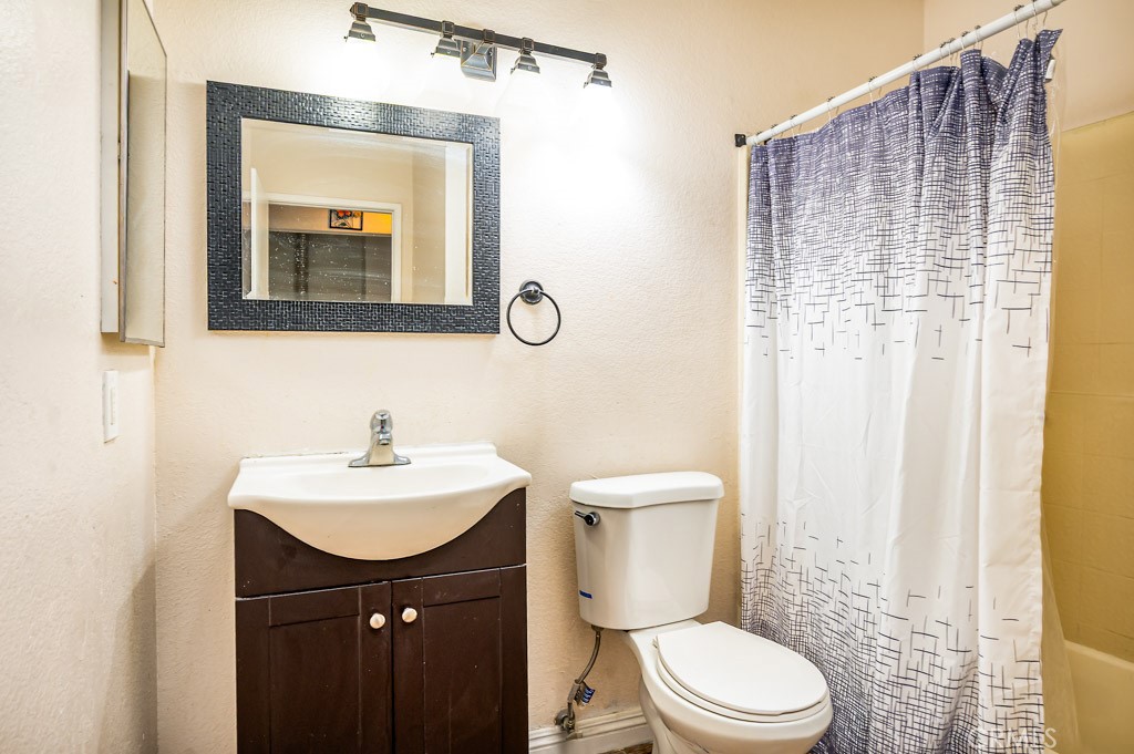 25899 Baylor Way Hemet, CA 92544 - Photo 12 of 29 a bathroom with a toilet sink and mirror