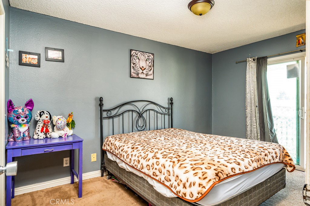 25899 Baylor Way Hemet, CA 92544 - Photo 13 of 29 a bed sitting in a bedroom next to a window