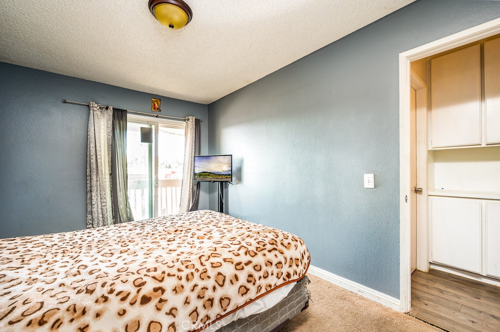 25899 Baylor Way Hemet, CA 92544 - Photo 14 of 29 a bedroom with a bed and a window