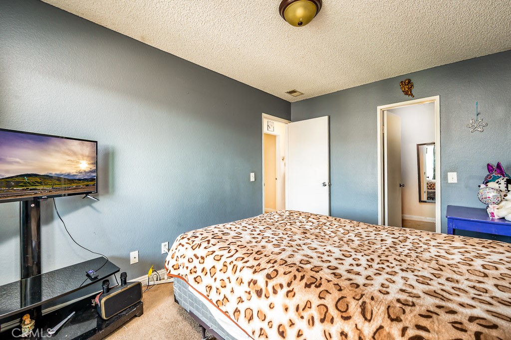 25899 Baylor Way Hemet, CA 92544 - Photo 15 of 29 a bedroom with a bed and a flat screen tv
