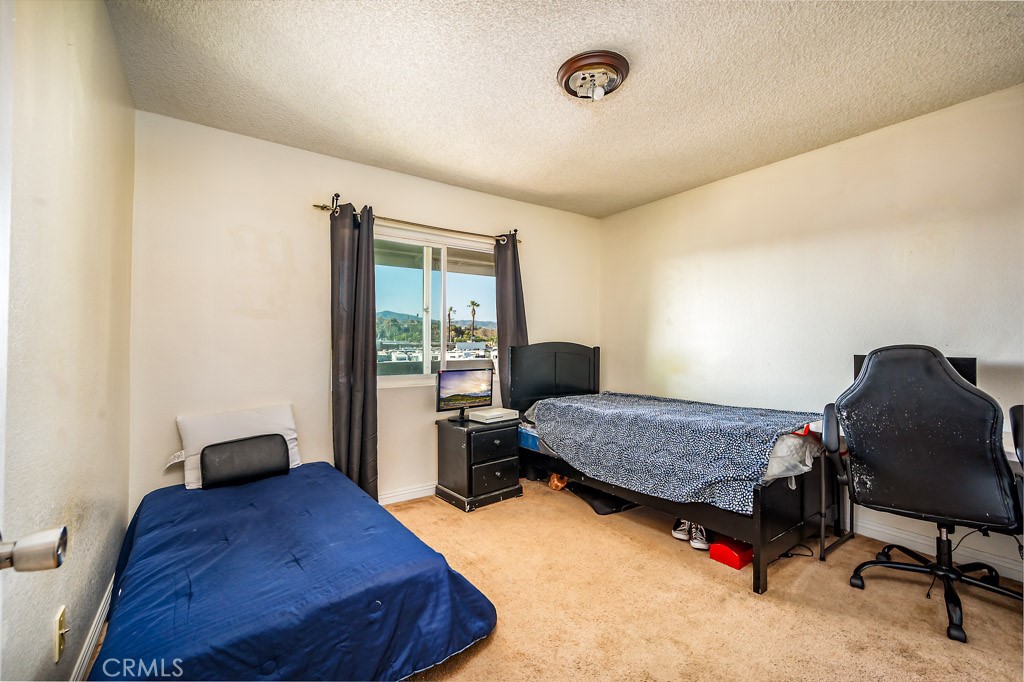 25899 Baylor Way Hemet, CA 92544 - Photo 17 of 29 a bedroom with a bed and wooden floor