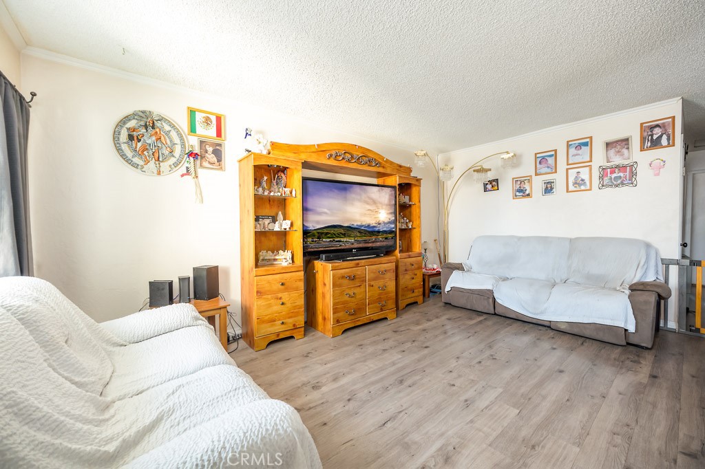 25899 Baylor Way Hemet, CA 92544 - Photo 2 of 29 a living room with furniture and a flat screen tv