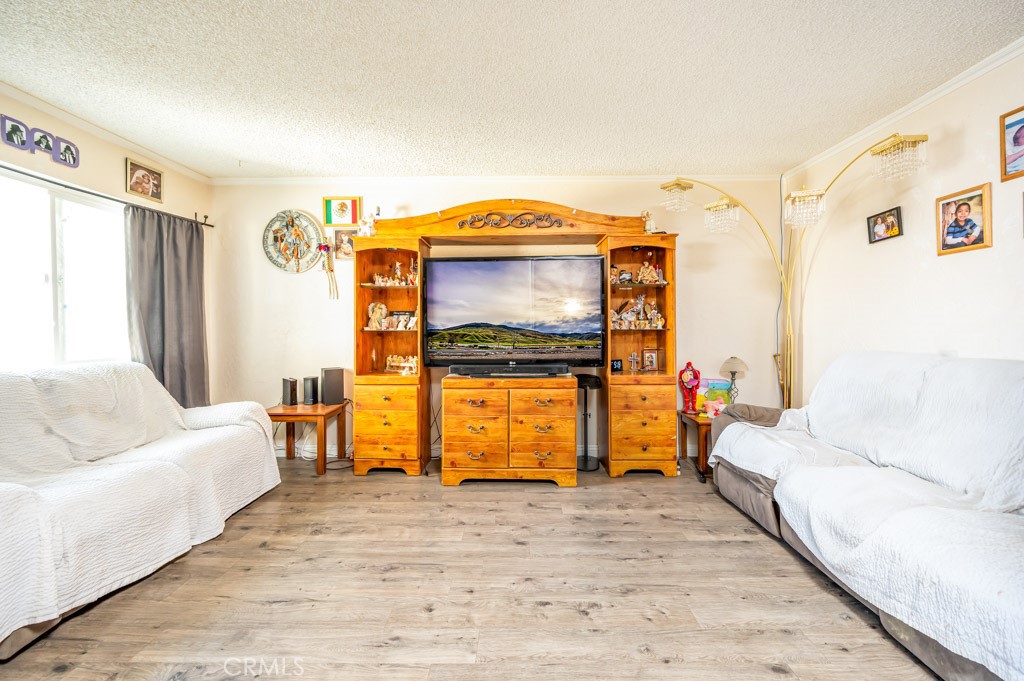 25899 Baylor Way Hemet, CA 92544 - Photo 4 of 29 a living room with furniture and a flat screen tv