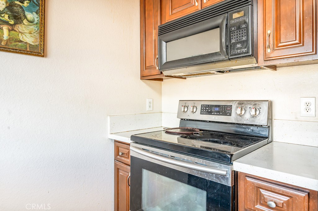 25899 Baylor Way Hemet, CA 92544 - Photo 9 of 29 a stove top oven sitting inside of a kitchen