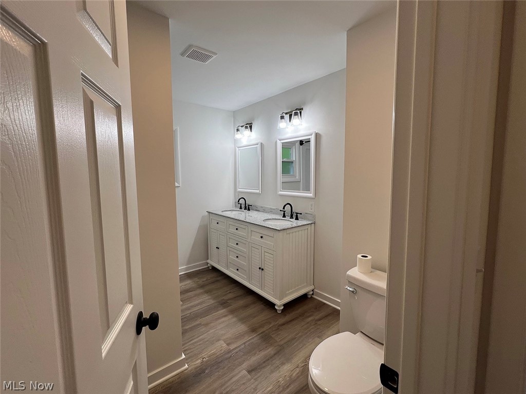 550 Johnson Road Wadsworth, OH 44281 - Photo 13 of 40 Bathroom with wood-type flooring, toilet, and double vanity