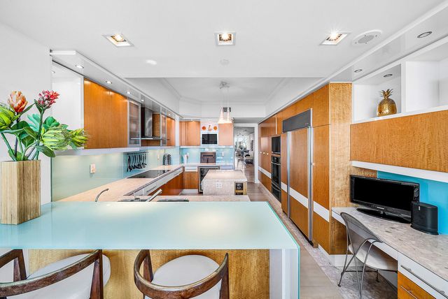 a living room with dining table and a potted plant