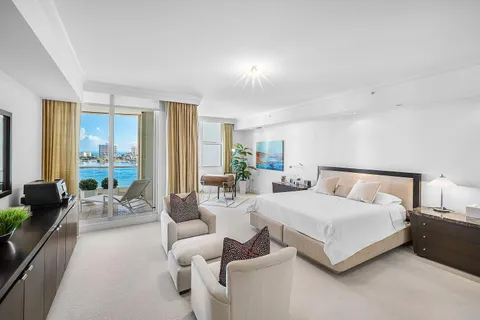 a bedroom with furniture and a large window