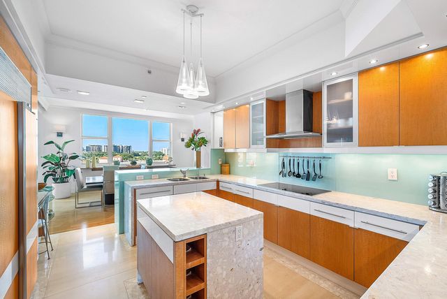 a view of a kitchen with a large window and a sink