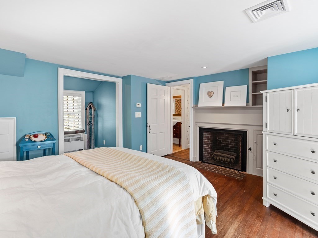 41 Sawyer Road Wellesley, MA 02481 - Photo 14 of 28 a bedroom with a bed and a fireplace