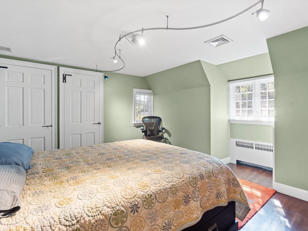 41 Sawyer Road Wellesley, MA 02481 - Photo 16 of 28 a bedroom with a bed and a chandelier