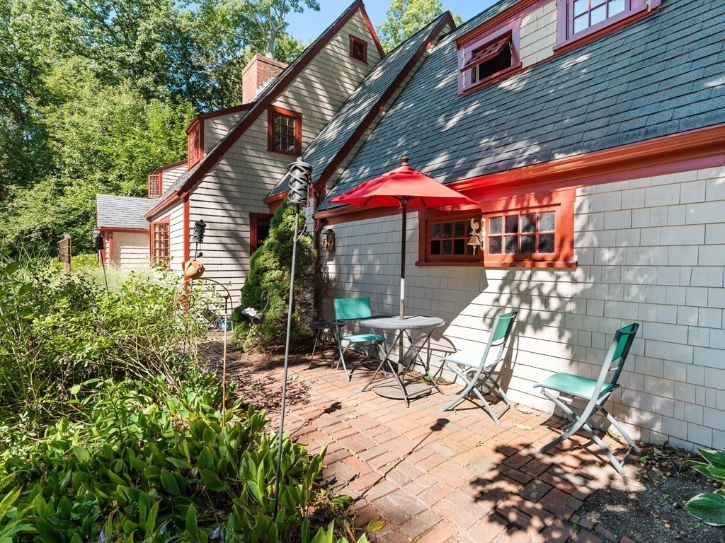 41 Sawyer Road Wellesley, MA 02481 - Photo 24 of 28 a view of patio with a table and chairs under an umbrella