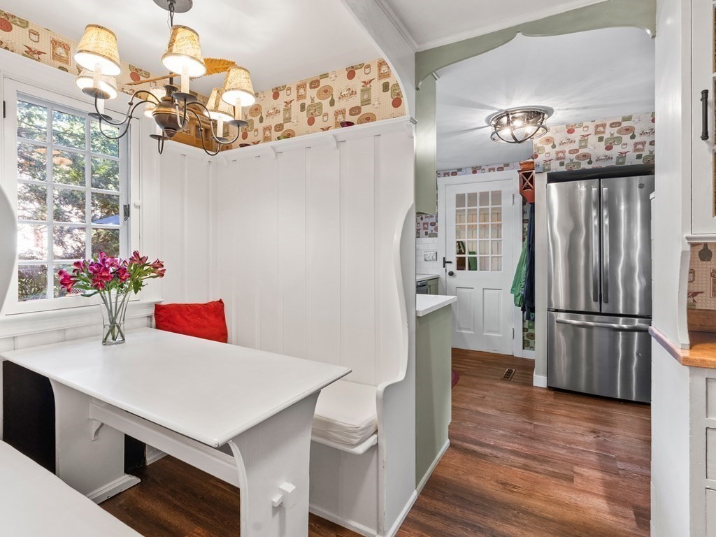 41 Sawyer Road Wellesley, MA 02481 - Photo 7 of 28 a kitchen with stainless steel appliances a refrigerator a sink dishwasher and a dining table with wooden floor