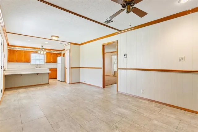 a view of a kitchen with a sink and a refrigerator