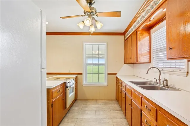 a kitchen with stainless steel appliances granite countertop a sink and a stove
