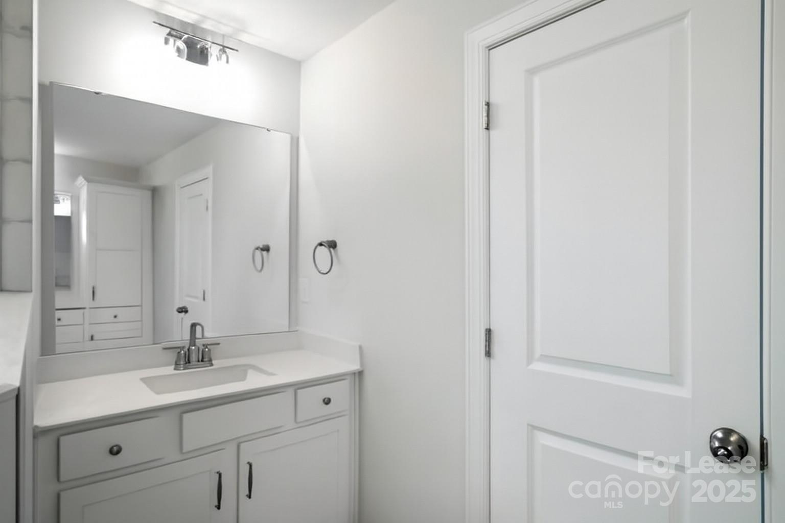 5409 Verona Road Charlotte, NC 28213 - Photo 16 of 20 a bathroom with a sink and a mirror