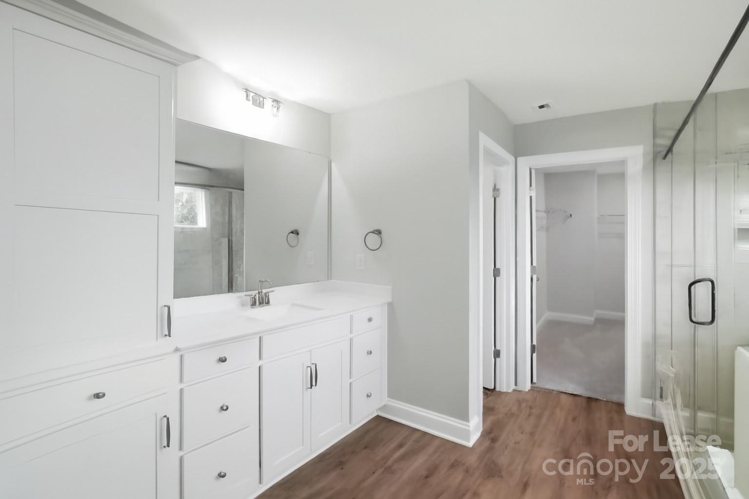 5409 Verona Road Charlotte, NC 28213 - Photo 9 of 20 a spacious bathroom with a double vanity sink a large mirror and shower