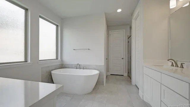 a spacious bathroom with a bathtub and sink