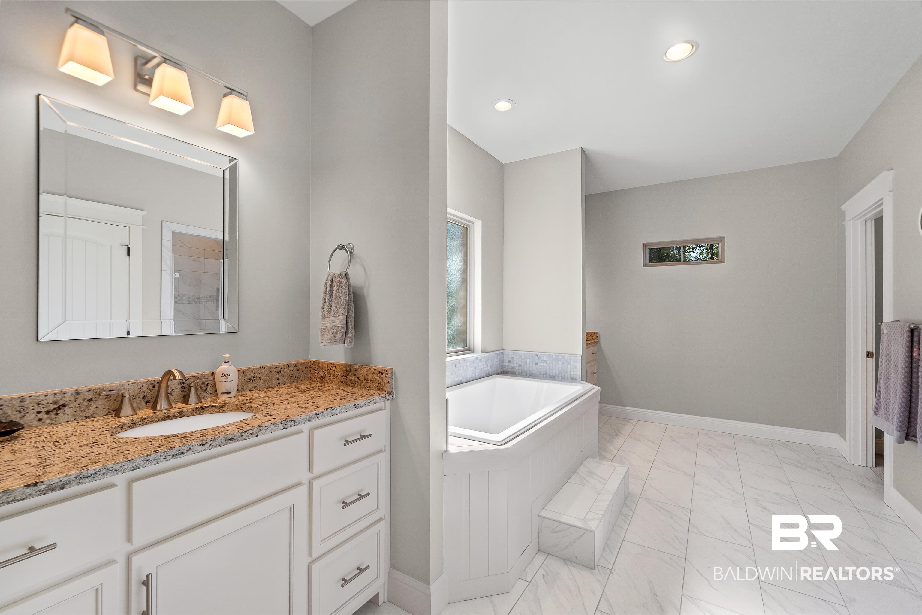 29530 St John Street Daphne, AL 36526 - Photo 16 of 38 Bathroom with vanity and tiled bath