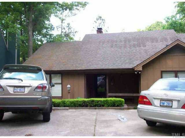 2939 Rue Sans Famille Raleigh, NC 27607 - Photo 1 of 1 a front view of a house with a yard and garage