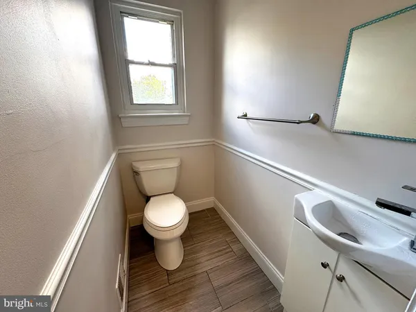 a bathroom with a toilet sink and window