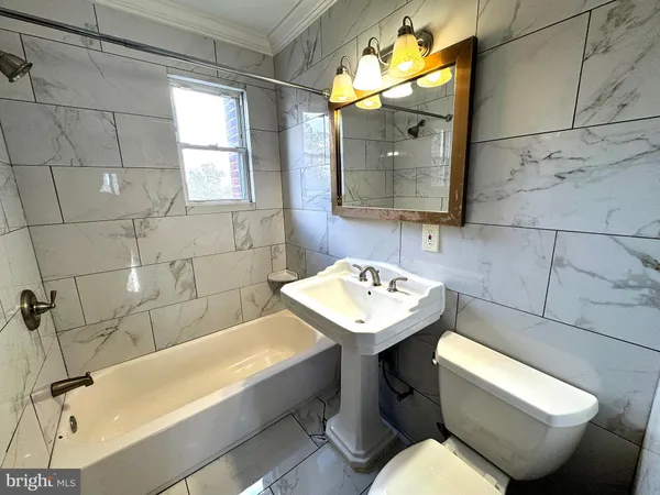 a bathroom with a sink mirror and toilet