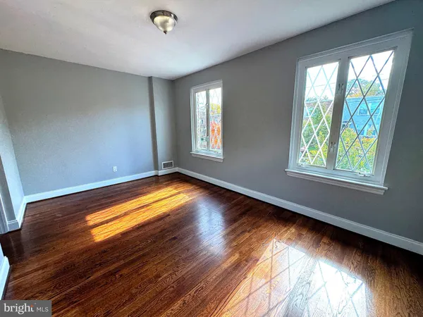 a view of room with window and wooden floor