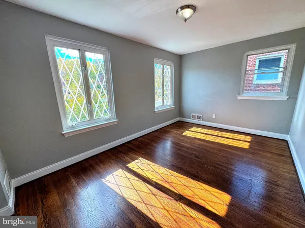 a view of room with window and wooden floor