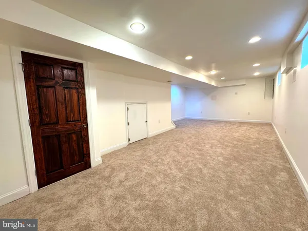 an empty room with closet and wooden door