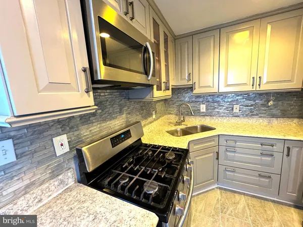 a kitchen with a stove and a microwave